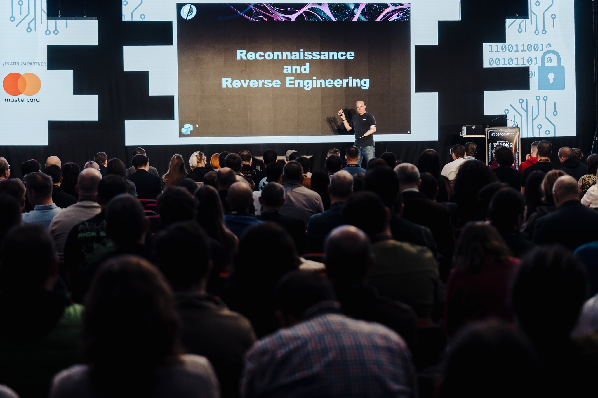 Speaker on stage at DefCamp 2025